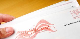 Hands holding official election mail envelope