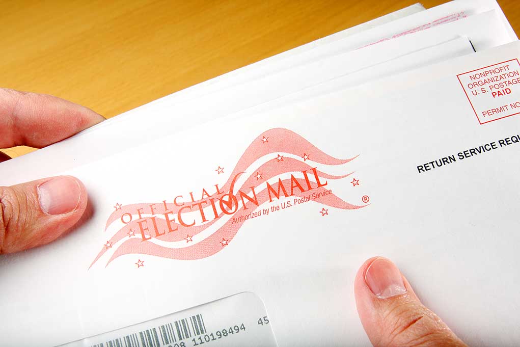 Hands holding official election mail envelope