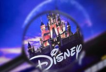 Magnifying glass focusing on Disney castle logo.