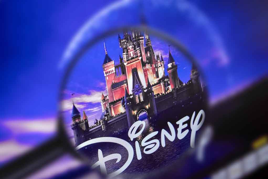 Magnifying glass focusing on Disney castle logo.