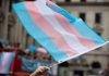 Transgender flag waving in a crowded street