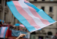 Transgender flag waving in a crowded street