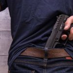 Person concealing a handgun in waistband