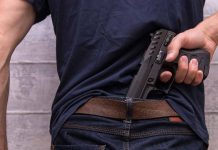 Person concealing a handgun in waistband