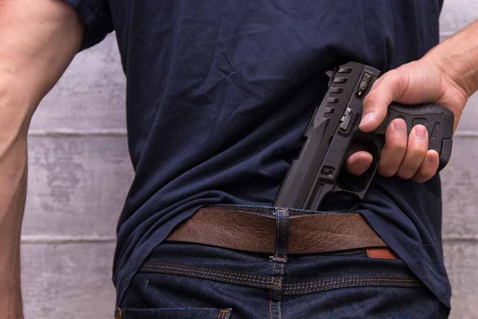 Person concealing a handgun in waistband