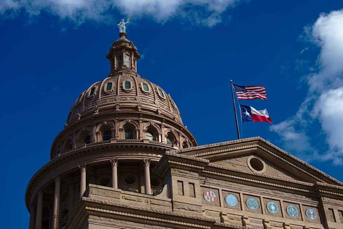 Texas capitol with US and Texas flags, blue sky