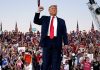 Trump standing in front of cheering crowd