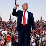 Trump standing in front of cheering crowd