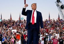 Trump standing in front of cheering crowd