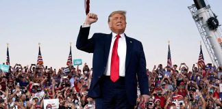 Trump standing in front of cheering crowd