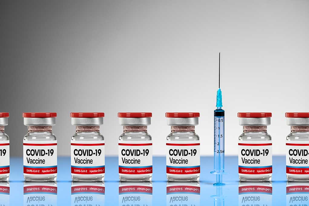 COVID-19 vaccine vials with syringe