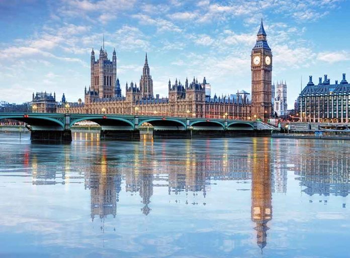 Westminster Bridge and Big Ben reflected in water.