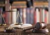 Gavel and scales on desk with books