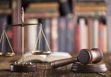 Gavel and scales on desk with books