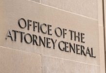 Office of the Attorney General sign on concrete wall.