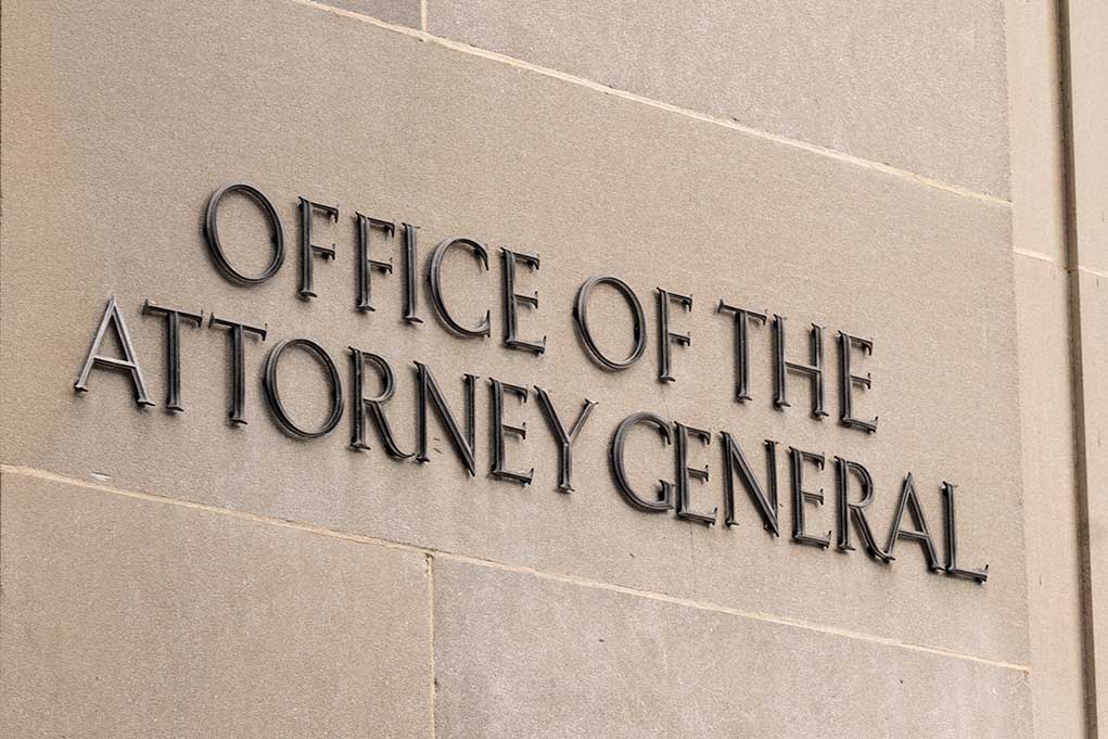 Office of the Attorney General sign on concrete wall.