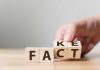 Hand flipping blocks between fact and fake