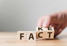 Hand flipping blocks between fact and fake