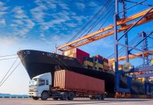 Cargo ship and truck at a busy port.