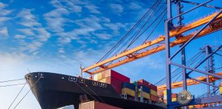 Cargo ship and truck at a busy port.