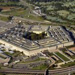 Aerial view of a large five-sided building.