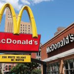 McDonald's restaurant with large advertising sign outside.