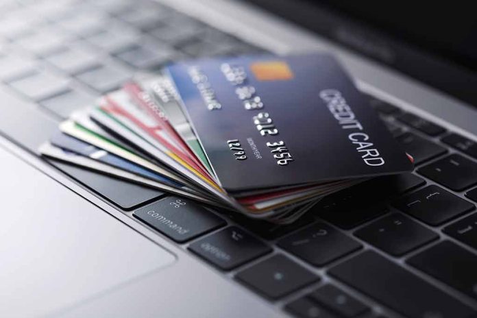 Stack of credit cards on a laptop keyboard.