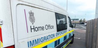 White immigration enforcement van parked by roadside