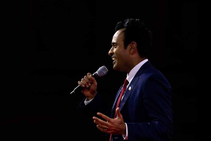 Man in suit speaking into microphone on stage