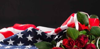 American flag with red roses on dark background