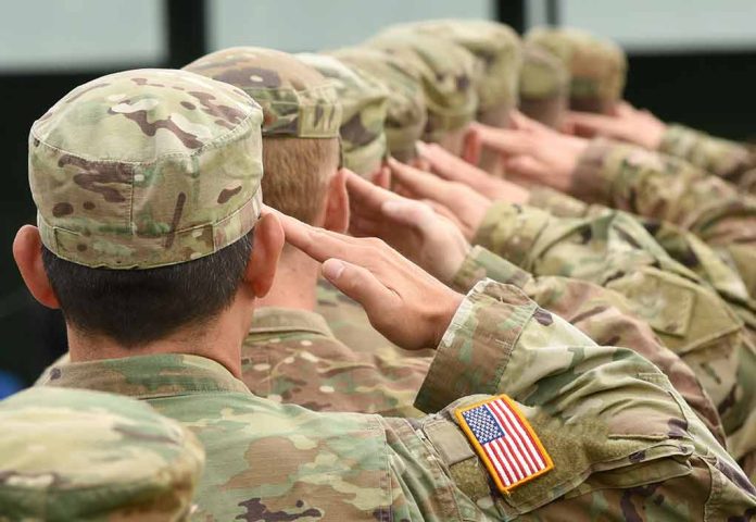 Soldiers in uniform saluting with American flag patch