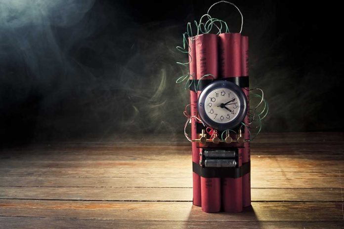 Dynamite bundle with a clock timer on wooden floor.