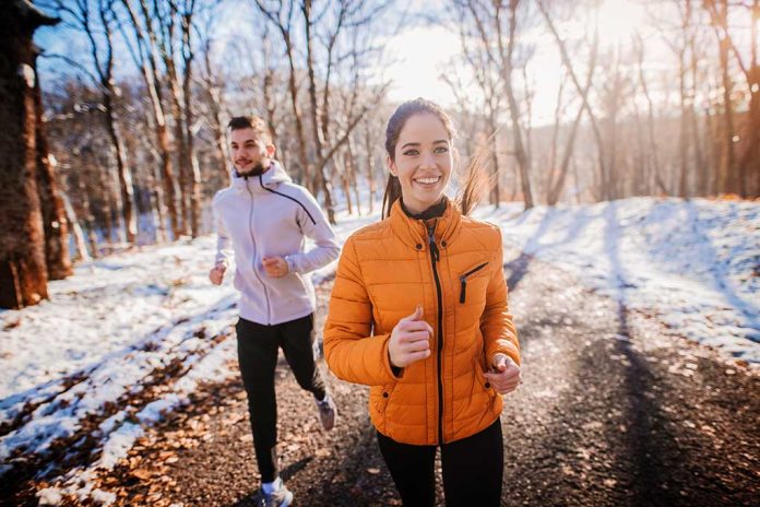 Two people jogging on a snowy path outdoors