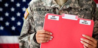 U.S. Army soldier holds a "Top Secret" folder.