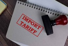 Notebook with "Import Tariff" stamp and rubber stamper.