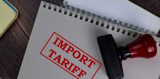 Notebook with "Import Tariff" stamp and rubber stamper.