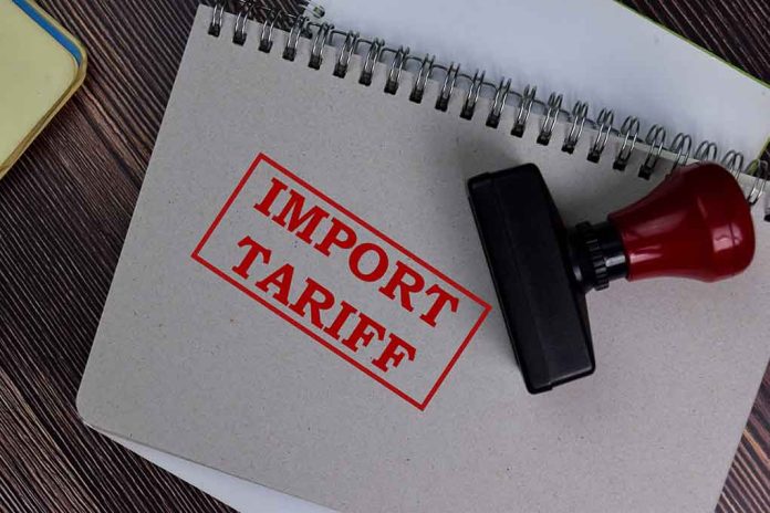 Notebook with "Import Tariff" stamp and rubber stamper.