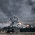 Explosion with smoke and fire in open landscape.