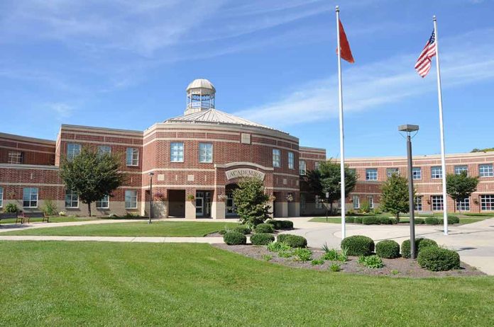 School building with flags and clear sky