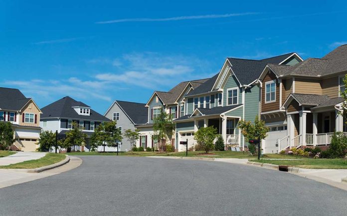 Suburban street with colorful, modern houses.