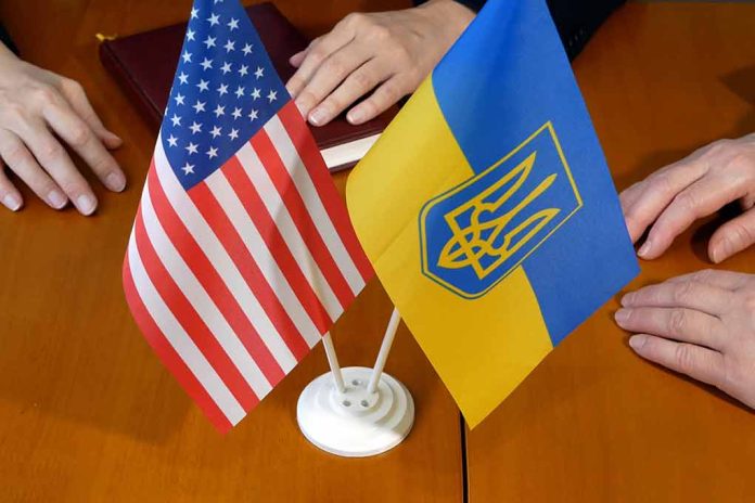 US and Ukraine flags on wooden table meeting