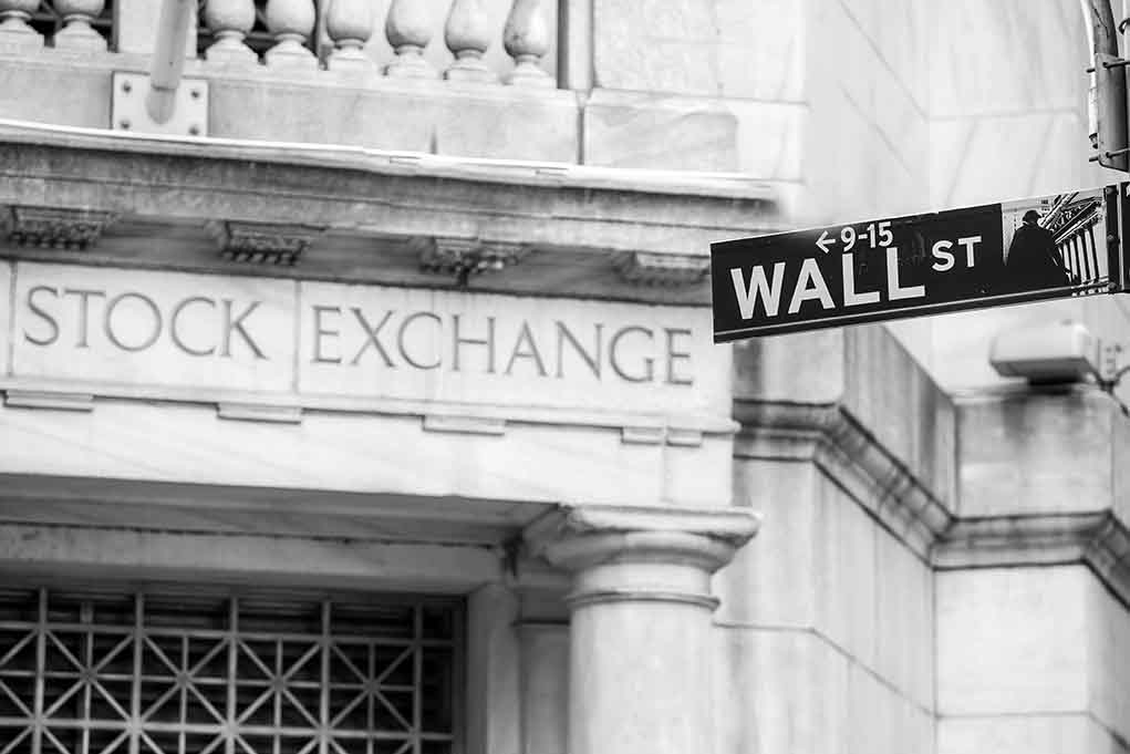 Stock Exchange building and Wall Street sign.