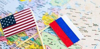 U.S. and Russian flags on a world map.