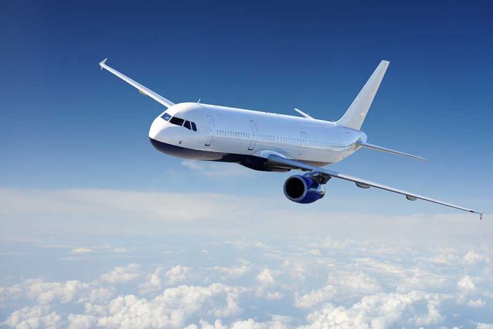 Airplane flying above clouds in blue sky