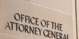 "Office of the Attorney General" sign on concrete wall.