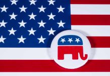 Republican elephant button on American flag background.