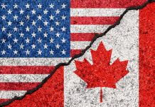 USA and Canada flags divided by a crack