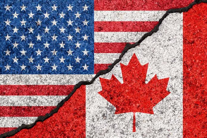 USA and Canada flags divided by a crack