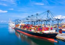 Container ship docked at a busy industrial port.