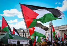 Protest with Palestinian flags waving in the air